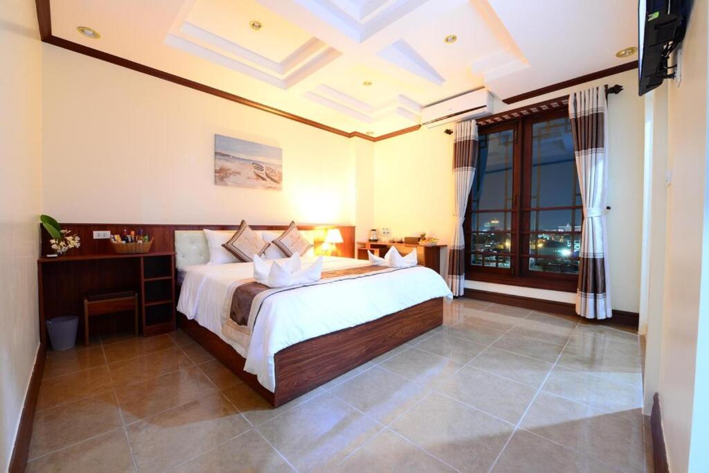 King Room with a king bed and a private balcony on the upper floors
